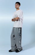 Pantalones deportivos holgados de felpa extrema con estampado gráfico